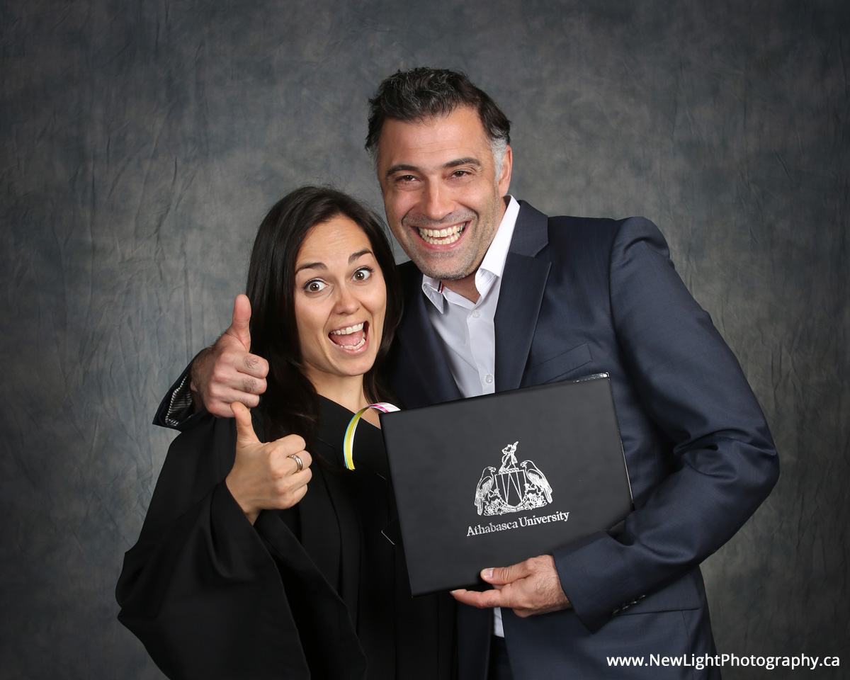 Graduating couple give a thumbs-up!